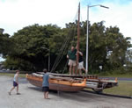 hoisting the mast on the double canoe